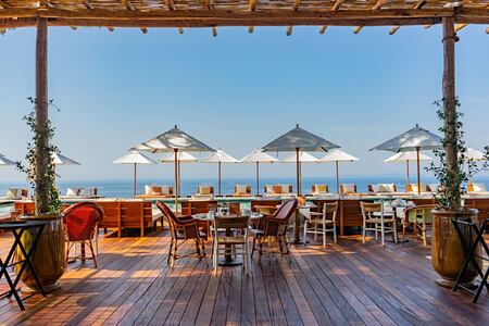 Outdoor dining area with sea view at lily of the valley cote dazur